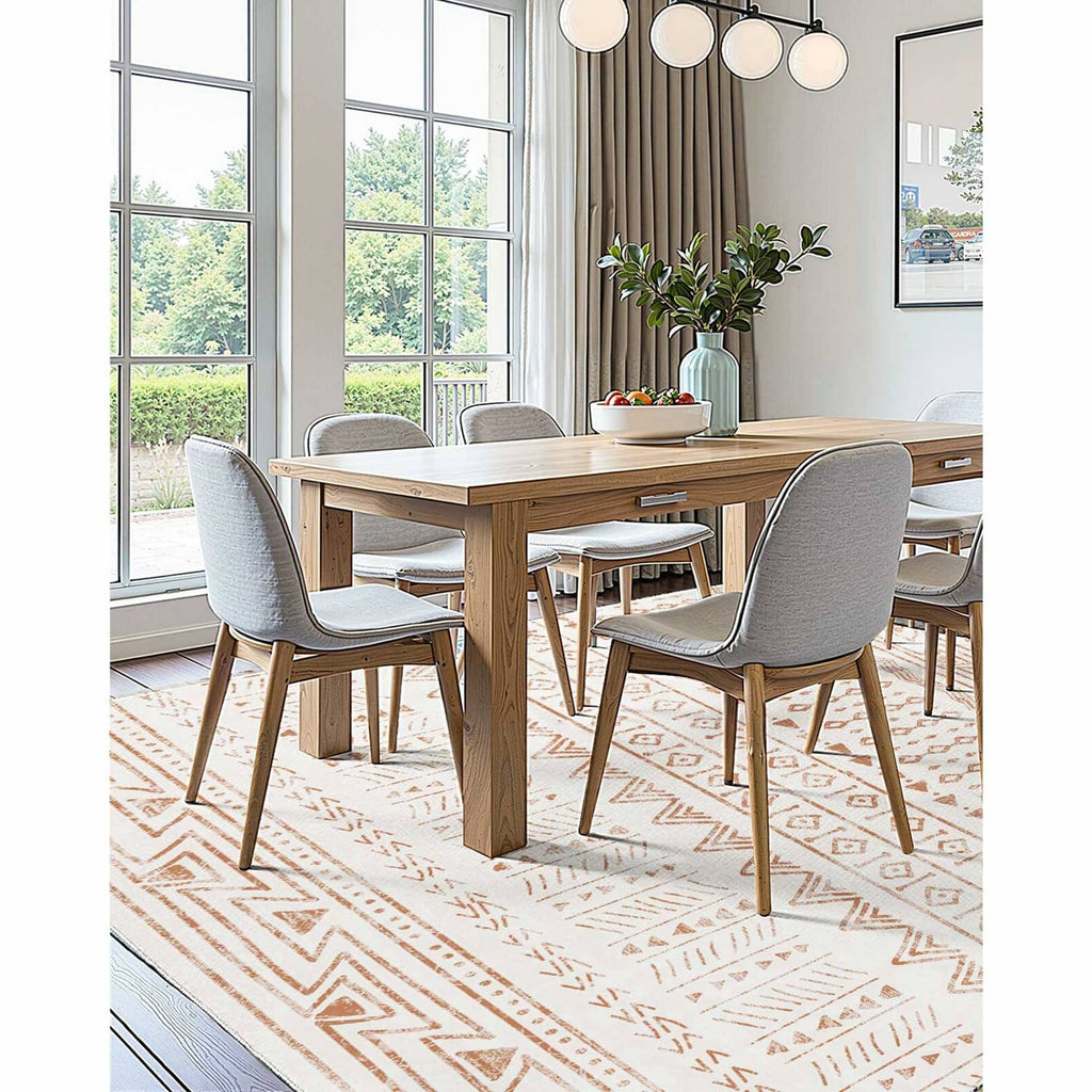 Beige geometric area rug with brown border and diamond pattern under dining table