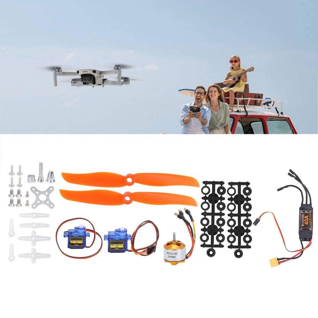 RC airplane kit components with orange propellers, servos, motor, linkage parts, and ESC