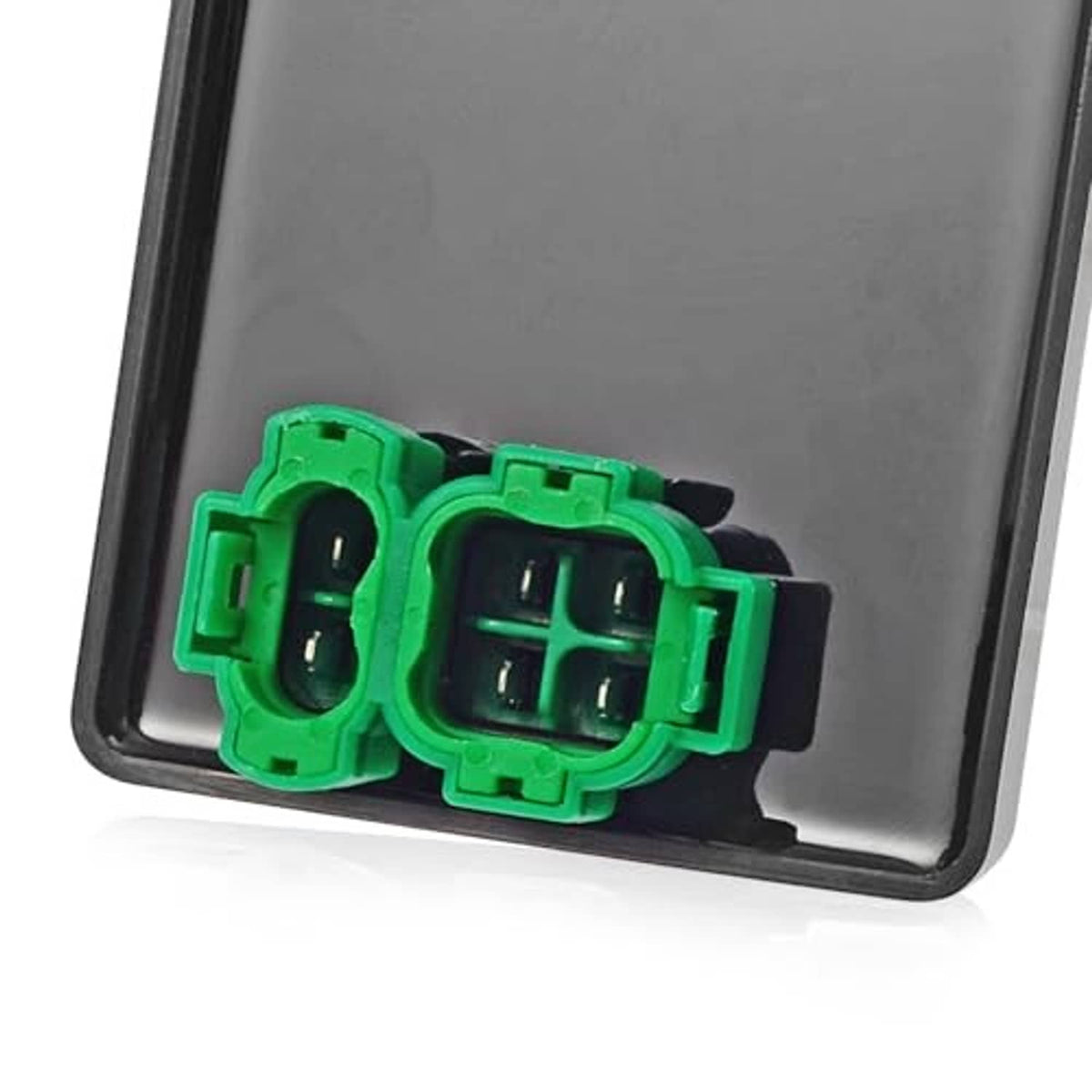 CDI connector detail: green dual plug on CDI box housing with internal contact ports