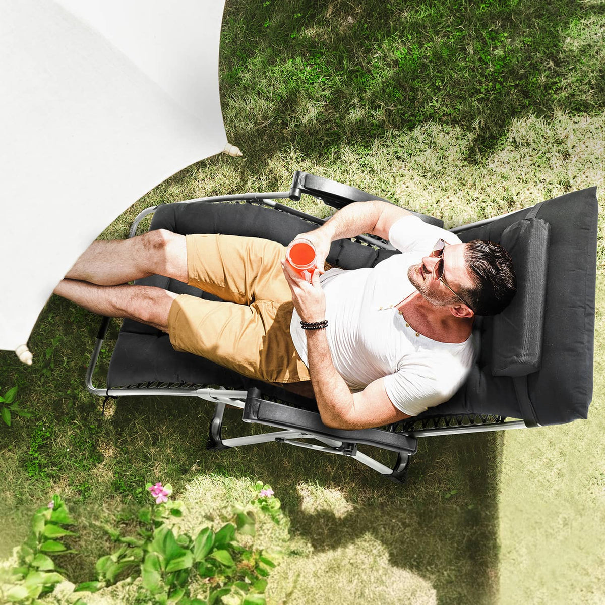 Black padded zero-gravity recliner chair with adjustable back and footrest.