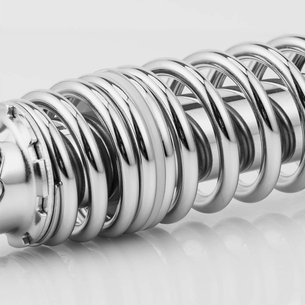 Close-up of chrome coiled spring on a motorcycle shock absorber