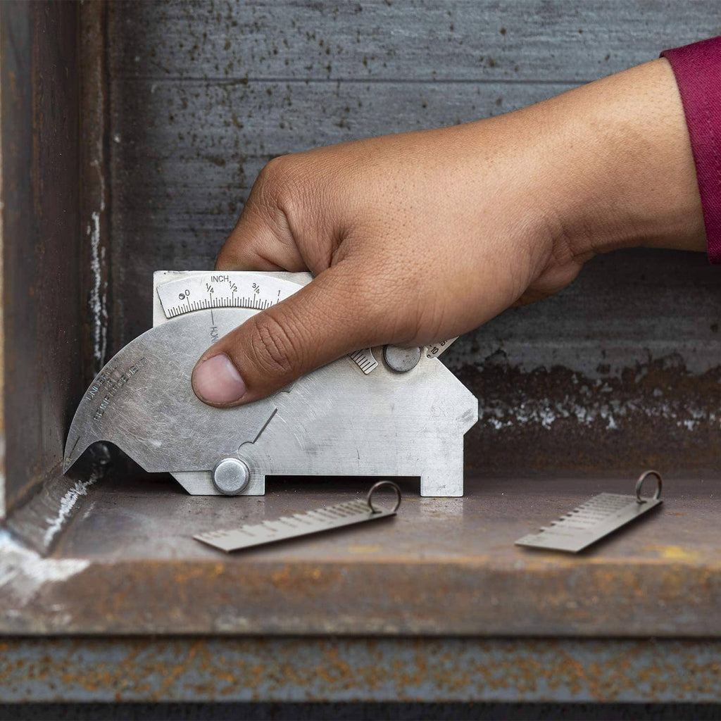 Hand using metal sheet thickness gauge on metal beam to check sheet thickness