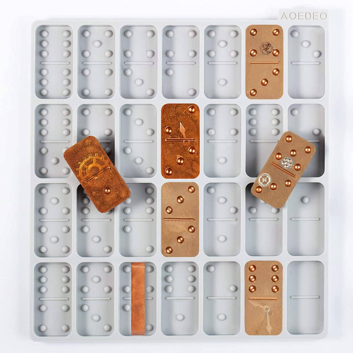 Gray silicone domino mold with multiple round-pip cavity shapes; includes copper samples