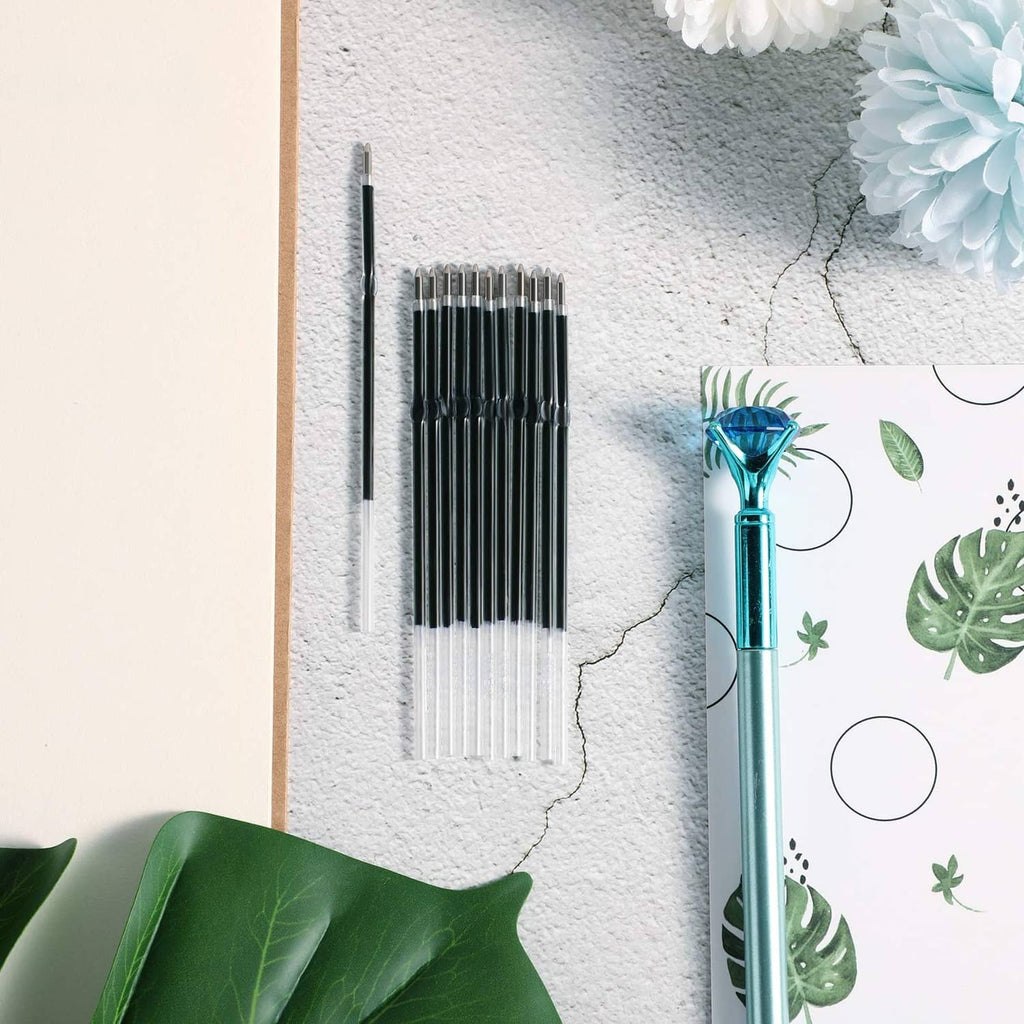 Retractable pen refills bundle with black barrels and clear tips, neatly stacked