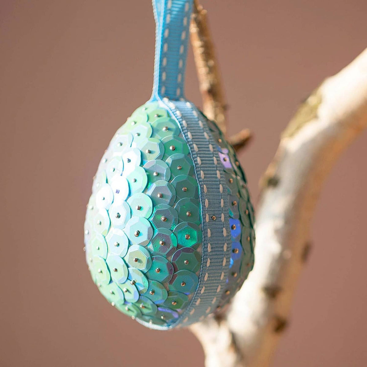 Teardrop sequin patch in aqua iridescent round cup style with reflective surface