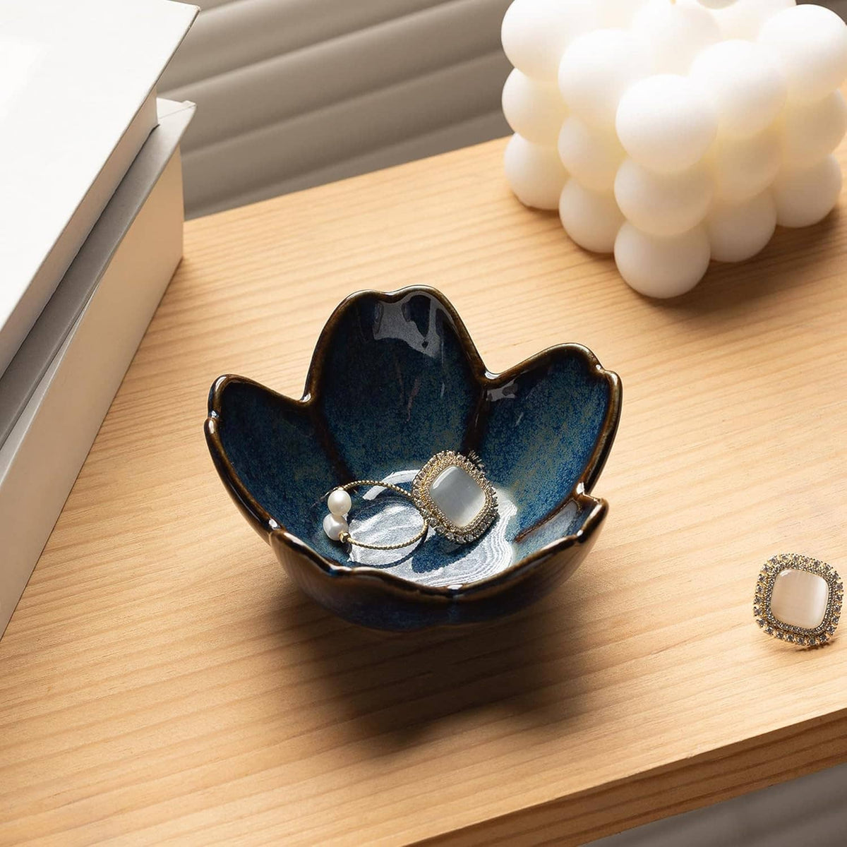 Blue ceramic flower-shaped ring holder dish with pearl and rhinestone ring accents