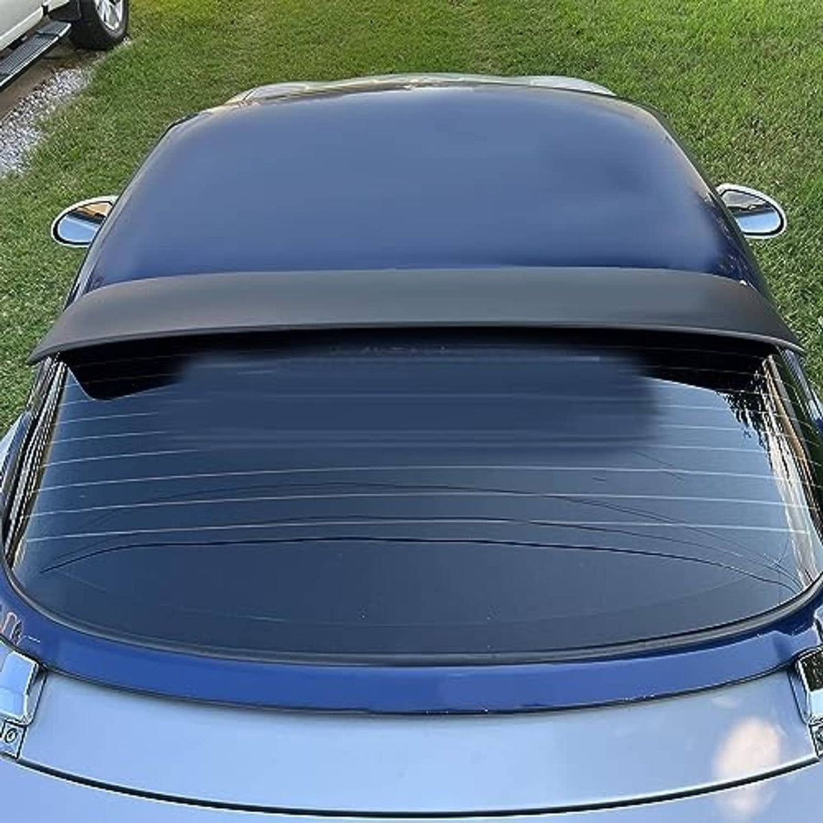 Matte black rear window roof spoiler installed on a blue hardtop from above