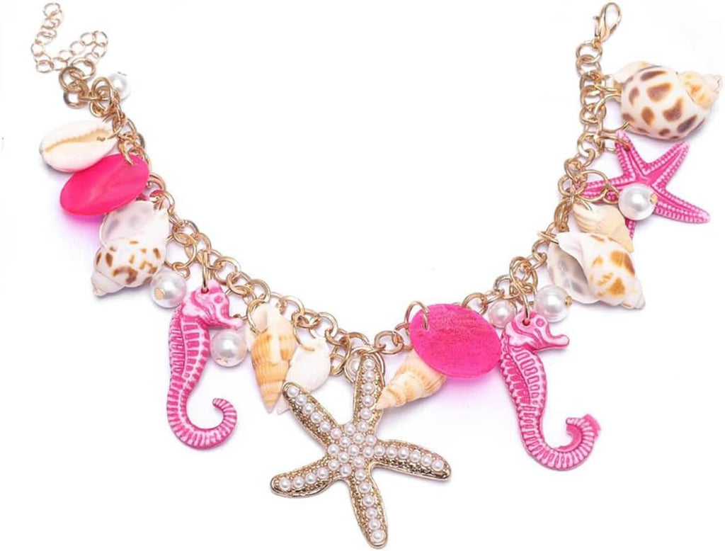 Gold charm bracelet with seahorses, starfish, shells, and faux pearl beads, heart clasp.