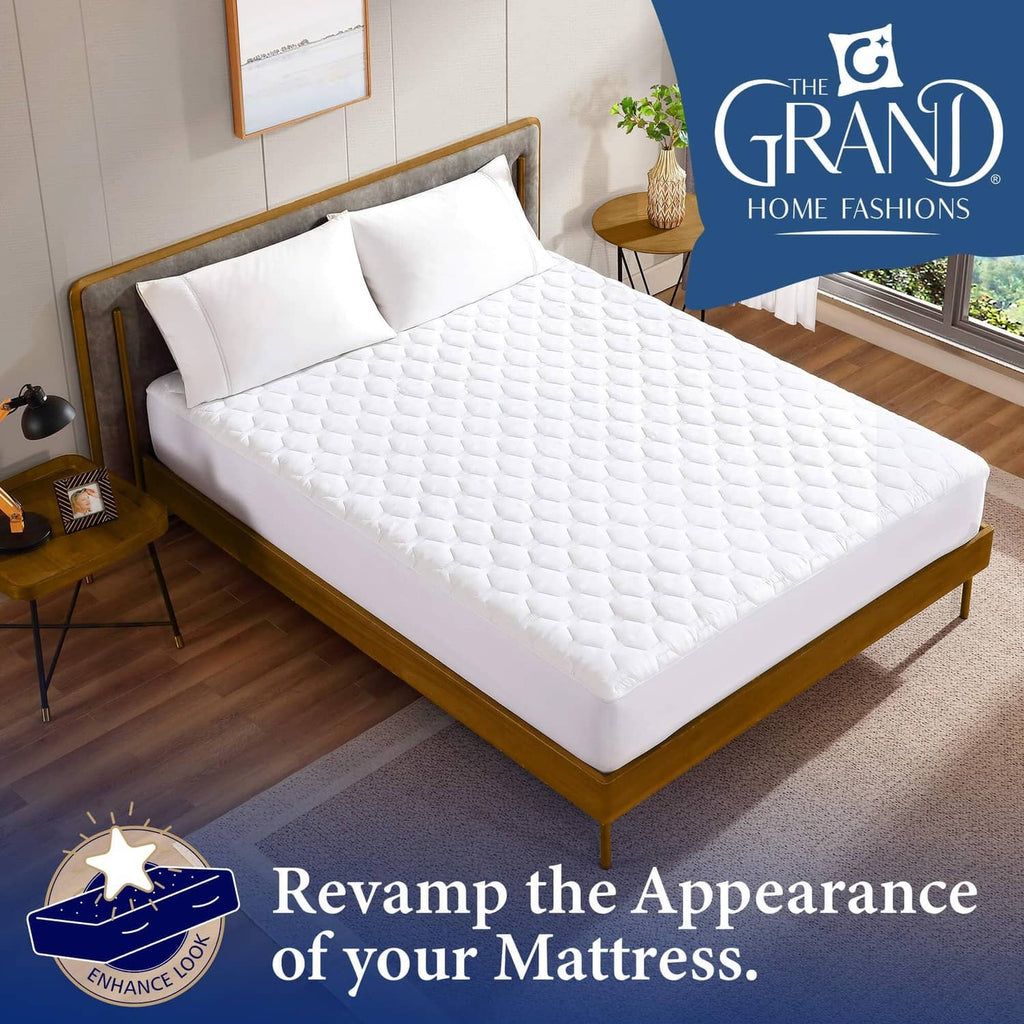 White quilted mattress pad topper laid flat on a full-size bed