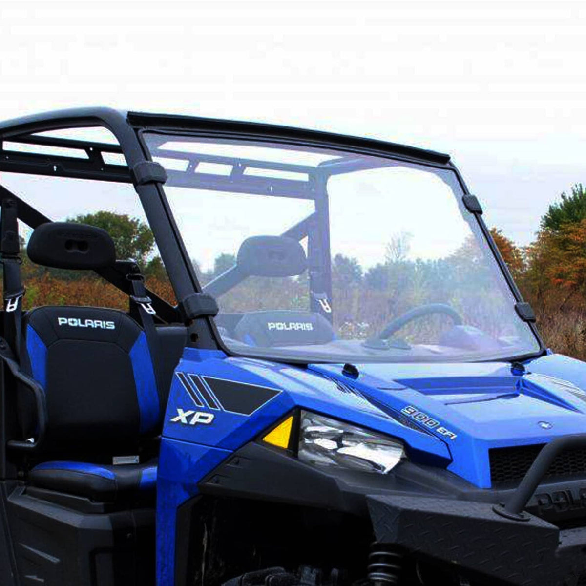 Clear windshield with black frame on a blue Polaris UTV cab