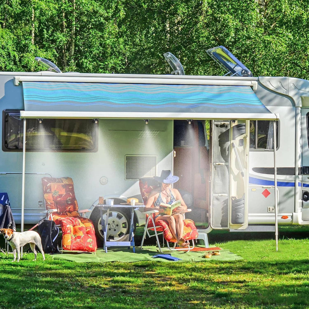 Outdoor cooling misting spray near RV camper on grass