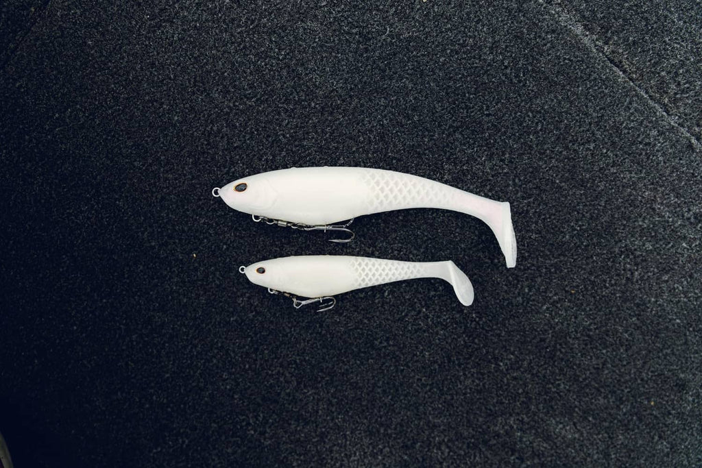 Two white soft plastic swim baits with lip detail and metal treble hook
