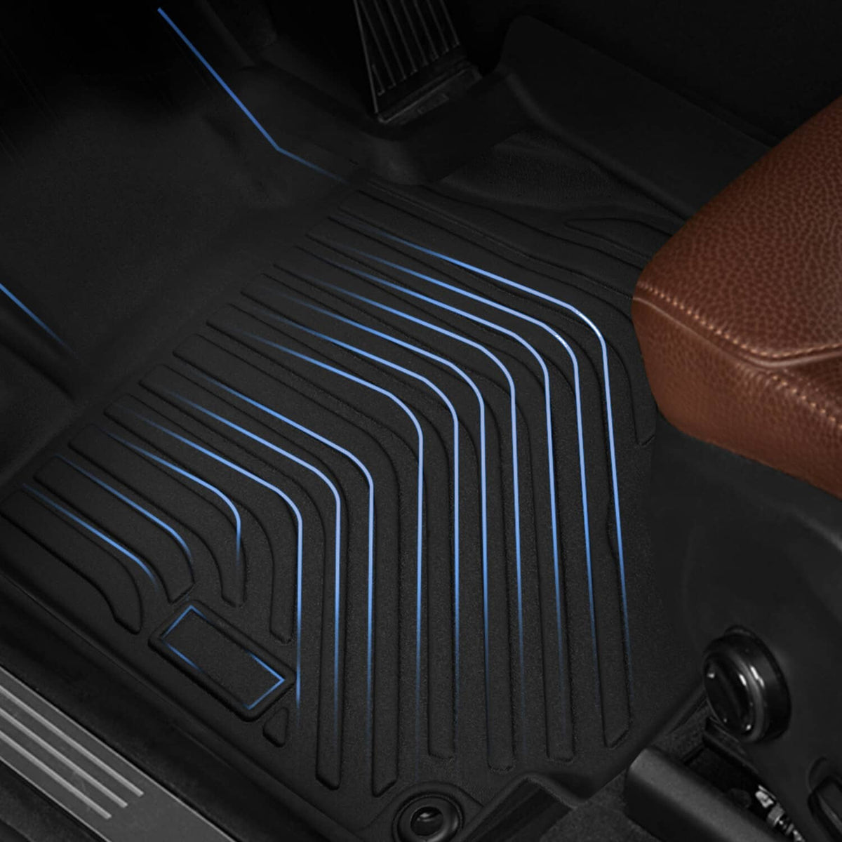 Black floor mat liner with deep ribbed grooves for grip, close-up texture