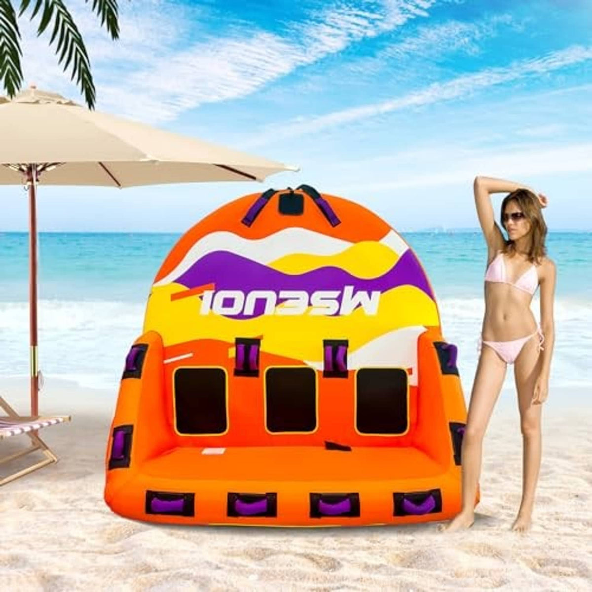Orange inflatable towable tube with colorful graphic print and front grab handles