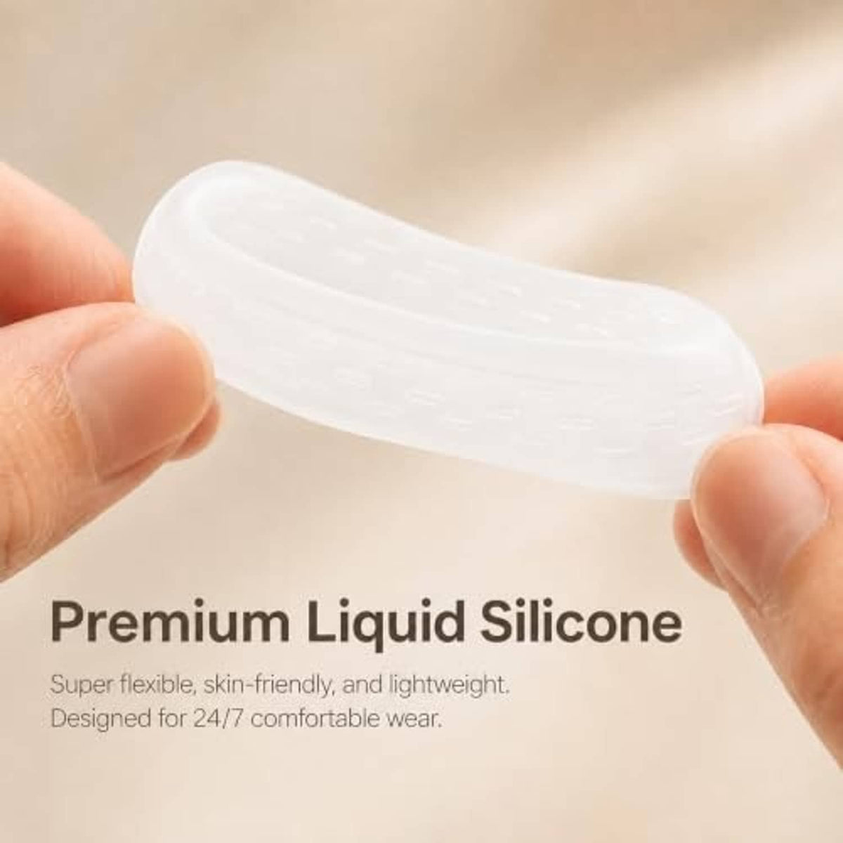 Clear liquid silicone ring protector sleeve for Oura Ring 5, held between fingers