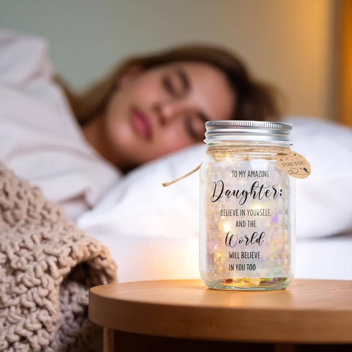 Clear LED mason jar on bedside table with warm light and “Daughter” verse message