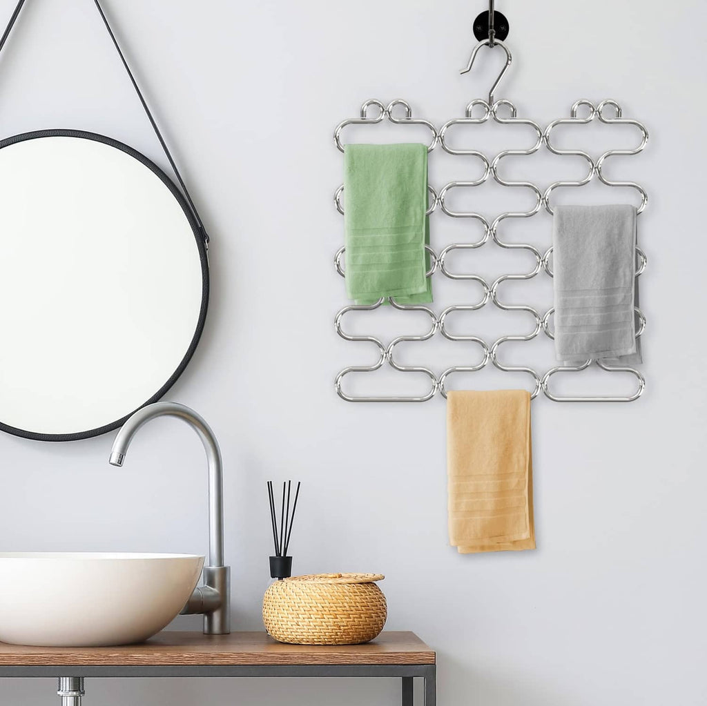 Chrome loop scarf hangers holding folded green, white, and beige scarves