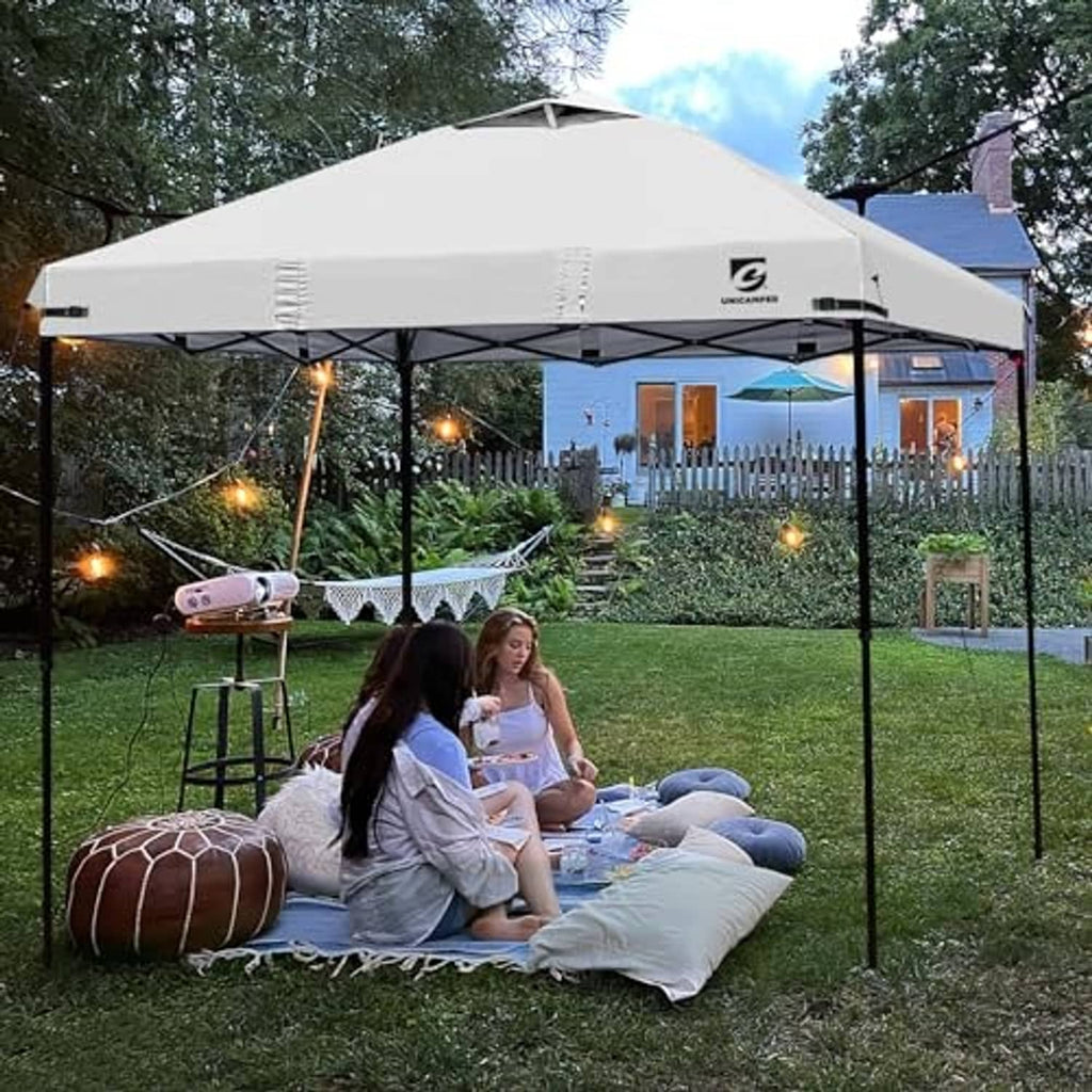 White pop-up canopy top cover with air vent over outdoor seating on the frame