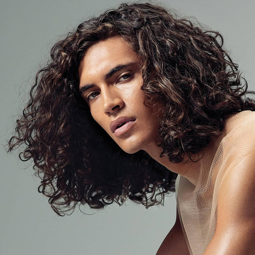 Curly dark hair on a model, styled for a softer, smoother look