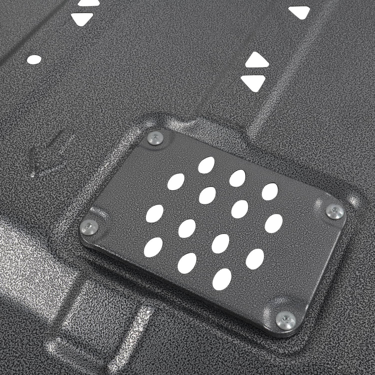 Close-up of black perforated access plate on transmission skid shield