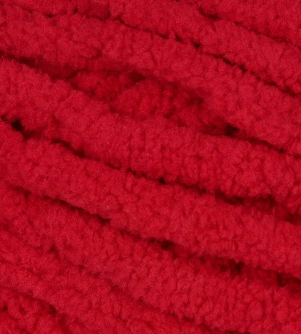 Close-up of cranberry red Bernat Blanket yarn knit texture with chunky loops