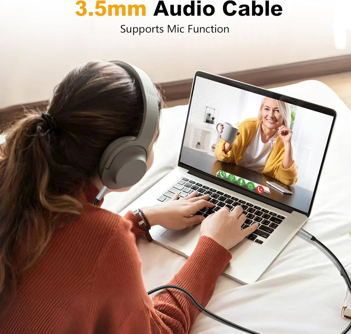 3.5mm aux audio cable plugged into a phone and laptop with braided black cord