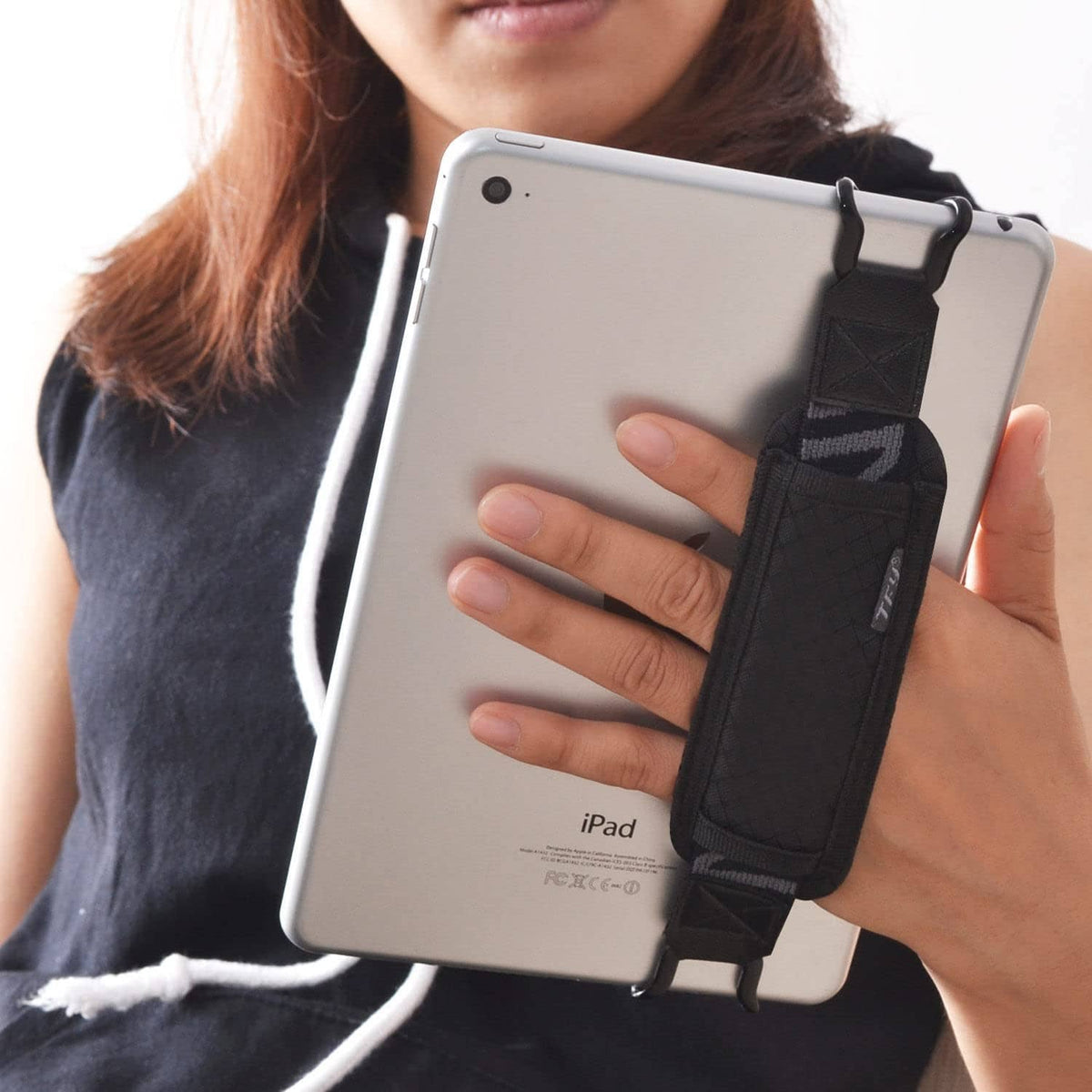 Tablet security hand strap holder with black webbing strap on back of iPad case