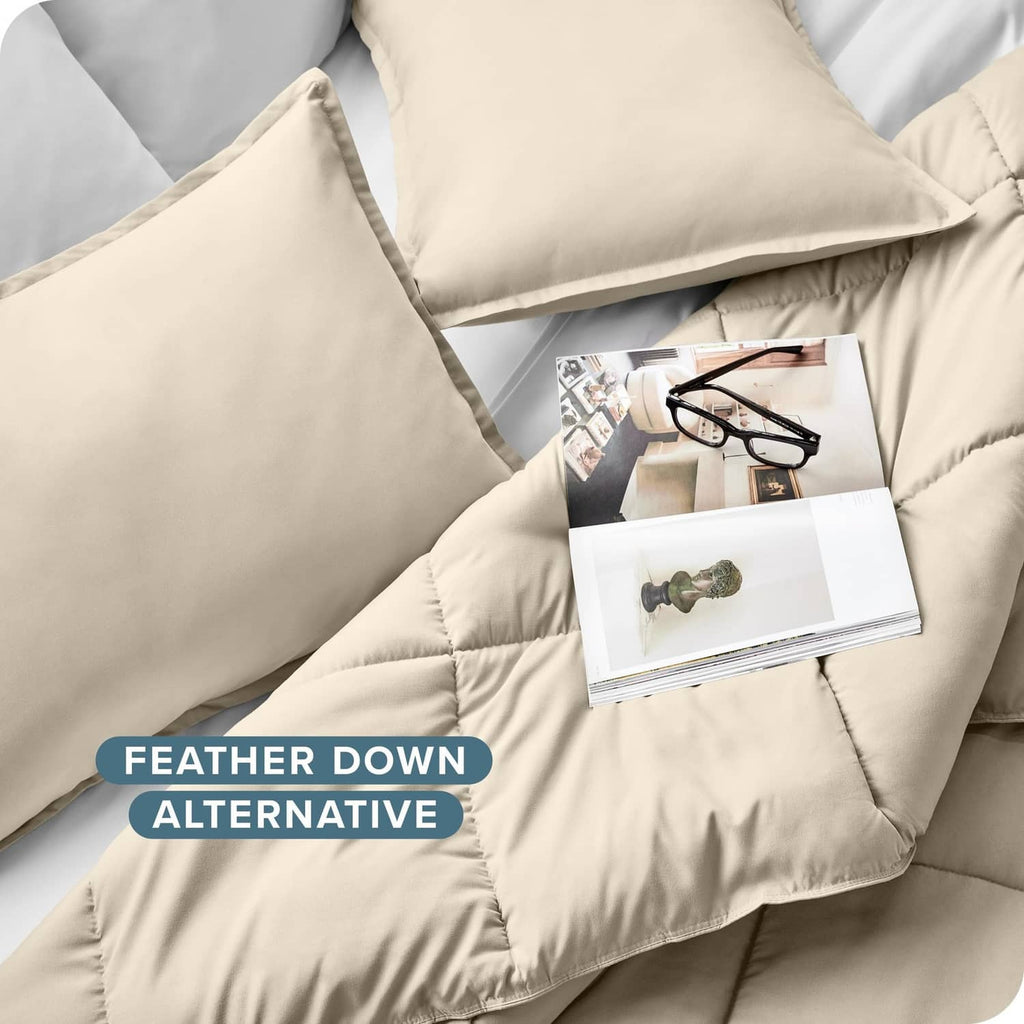 Cream quilted down alternative comforter with matching pillow shams, soft stitched corners