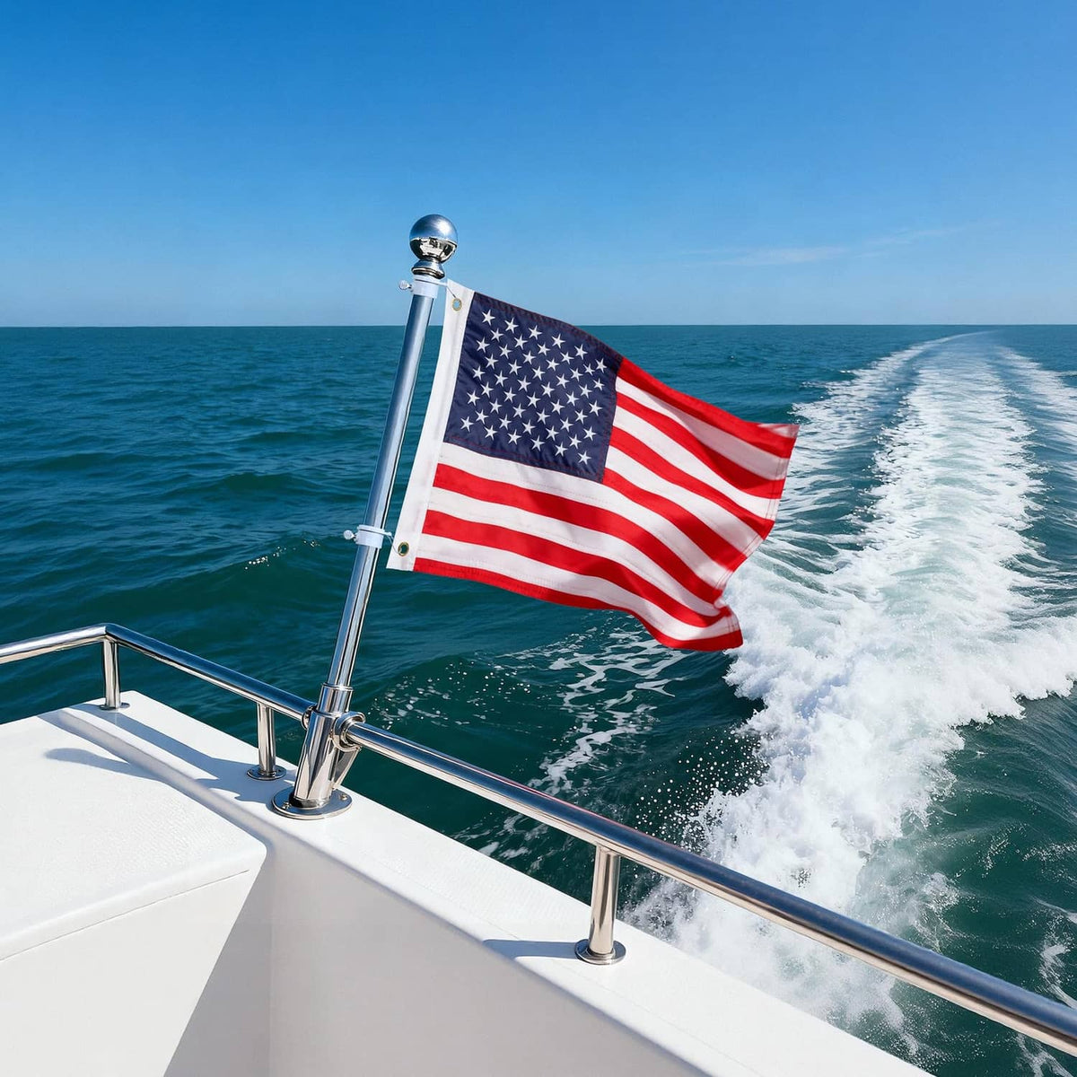 American boat flag flying from a mounted pole on a speedboat at sea