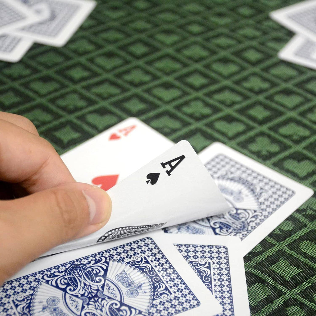 Poker table speed cloth in green diamond pattern with playing cards on top