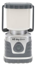 Portable LED lantern with white light housing, gray ribbed sides, and power button