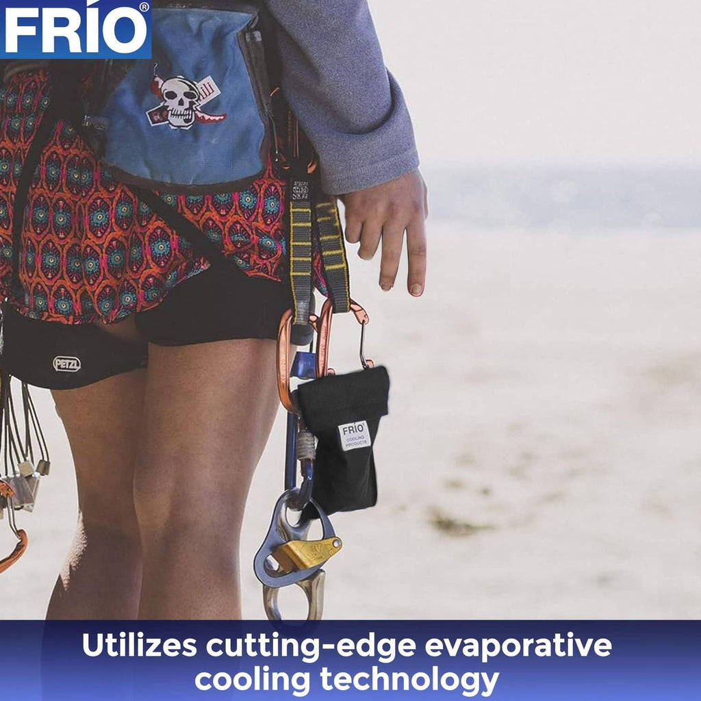 FRIO mini cooling wallet, black pouch with FRIO badge, held in hand