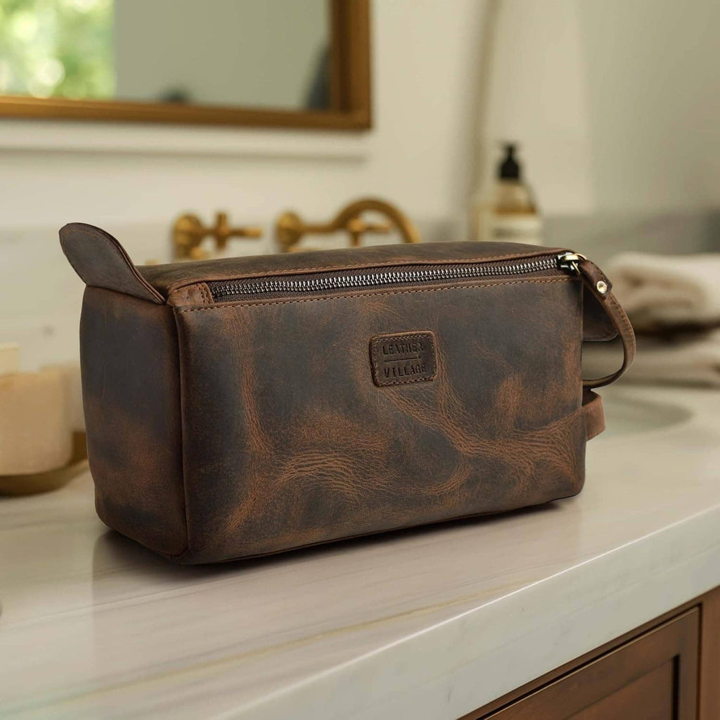 Brown leather toiletry bag with zip closure and embossed logo patch on front