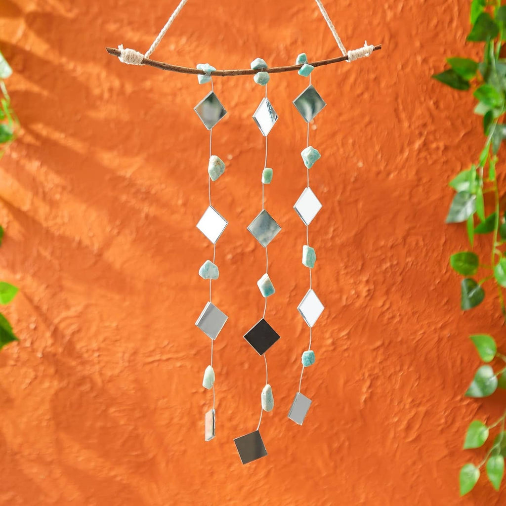 Small square mirror tiles strung with beads in a hanging craft garland