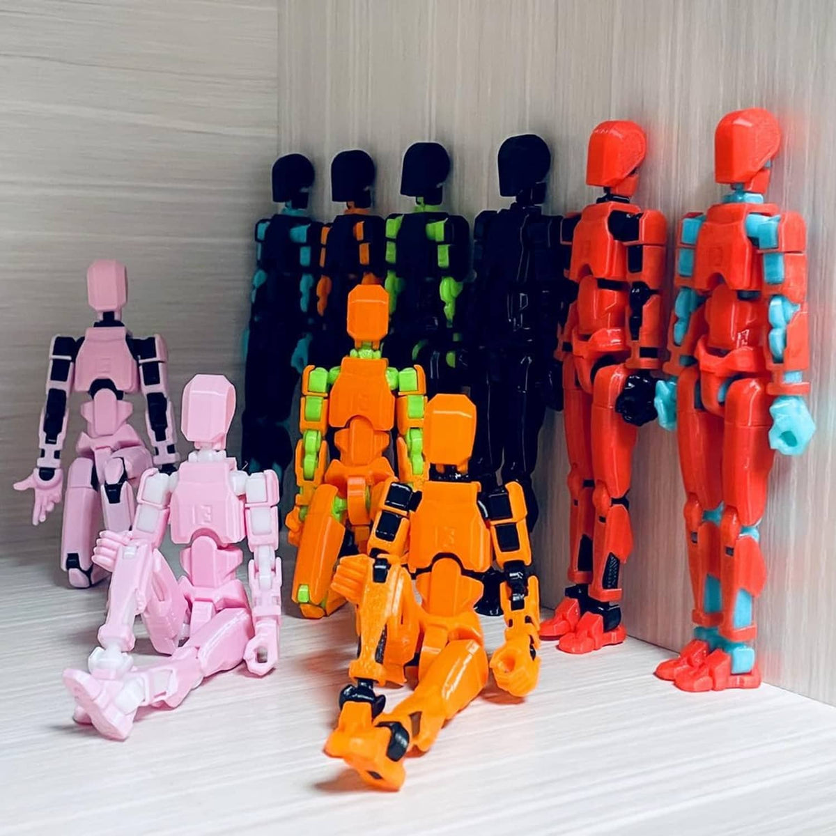 Block robot action figure set with pink, yellow, cyan, and red figures