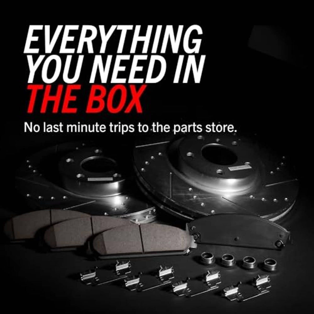 Brake kit components with two drilled rotors, pads, and assorted mounting hardware