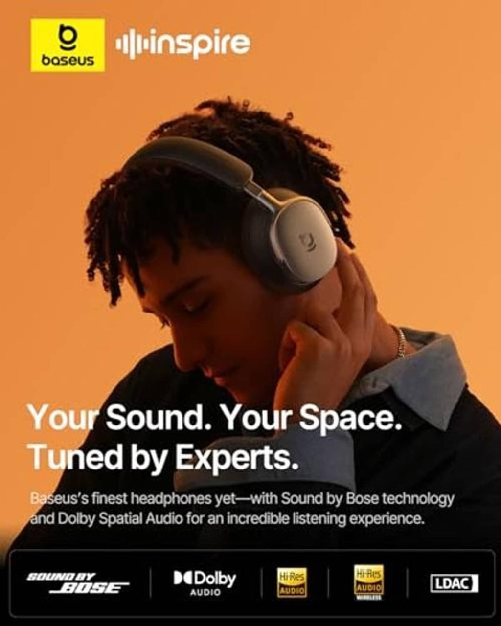 Over-ear wireless headphones on a person, dark padded earcups and headband