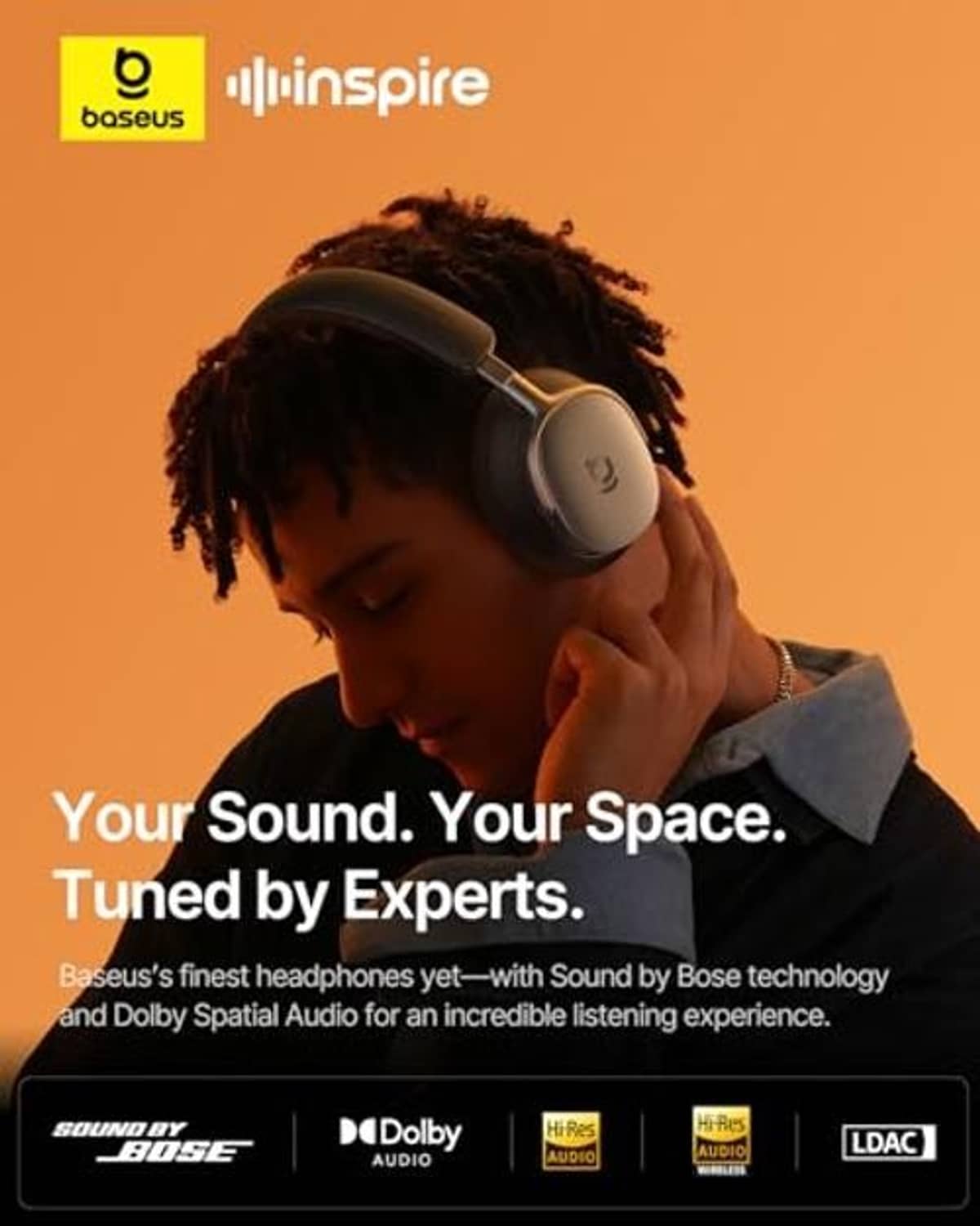 Over-ear wireless headphones on a person, dark padded earcups and headband