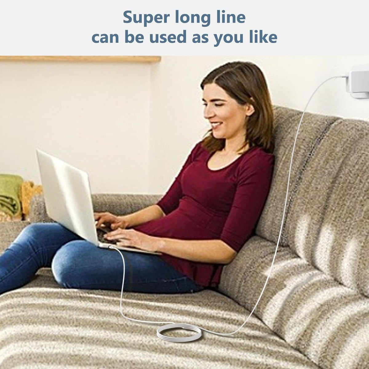 White USB-C charger with extra-long cable for charging a laptop