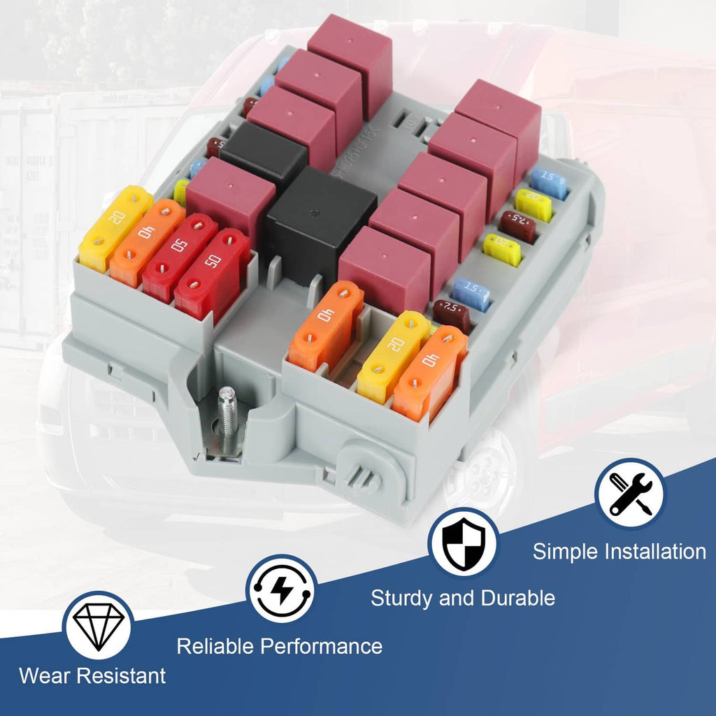 Distribution fuse box with gray tray and clustered red and orange fuse blocks, close-up angle.
