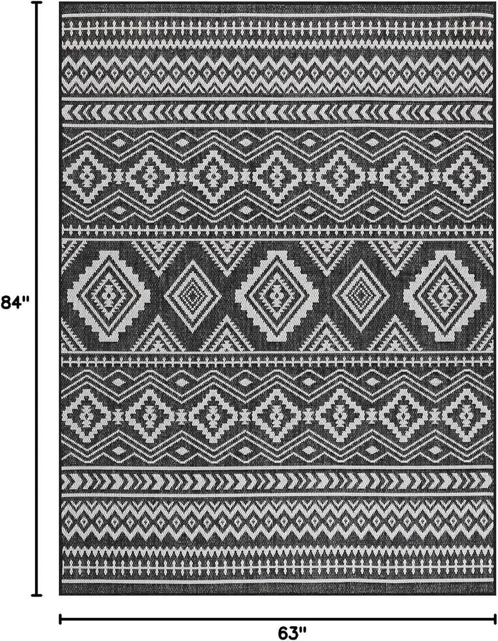 Geometric black-and-white rug with diamond motifs and measurement guide borders