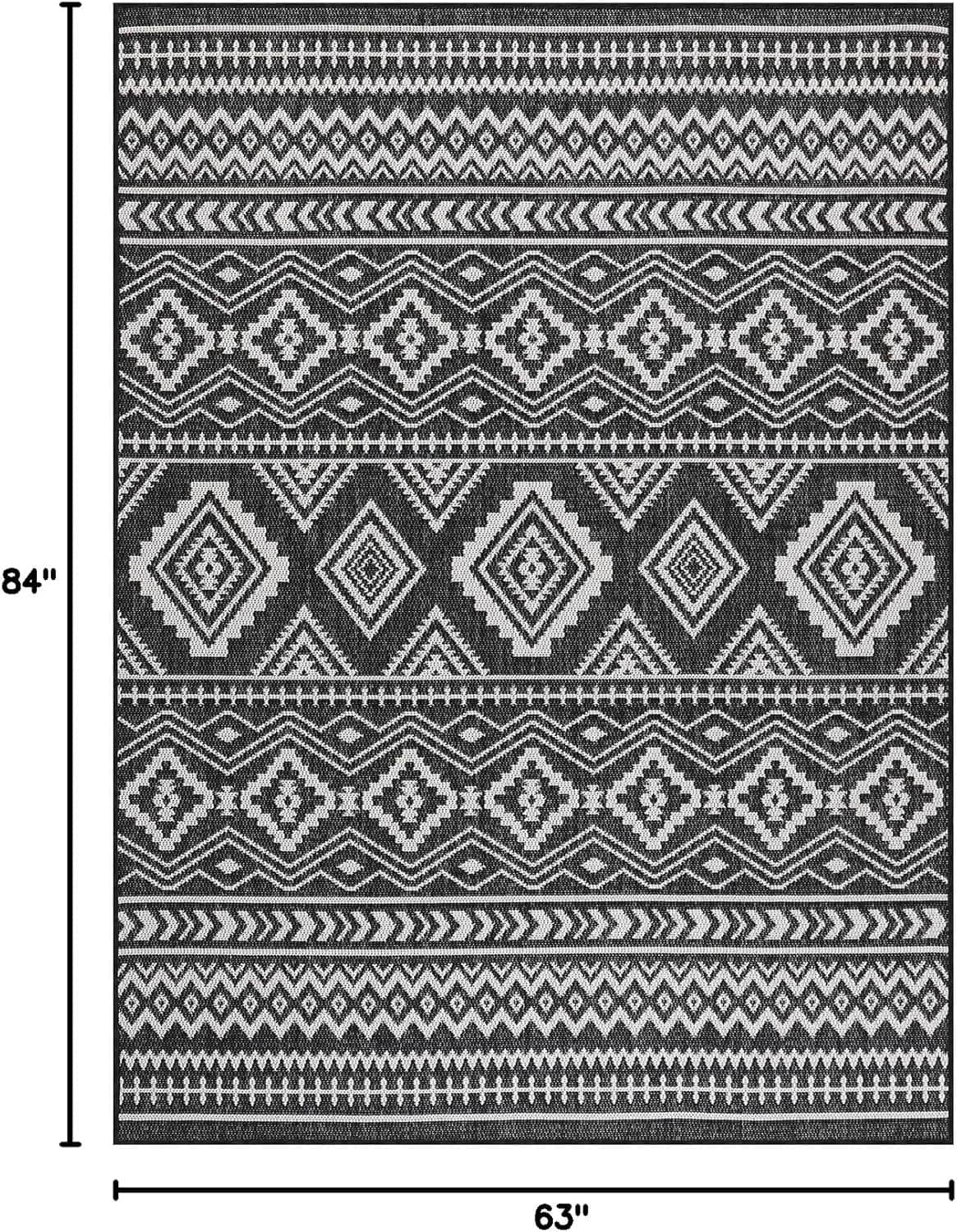 Geometric black-and-white rug with diamond motifs and measurement guide borders