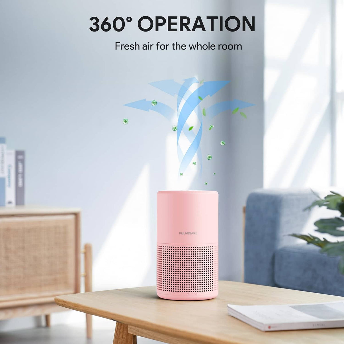 Pink air purifier on a wood table near a couch, compact cylindrical shape