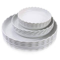 White round plastic plates with wavy scalloped rim, stacked set