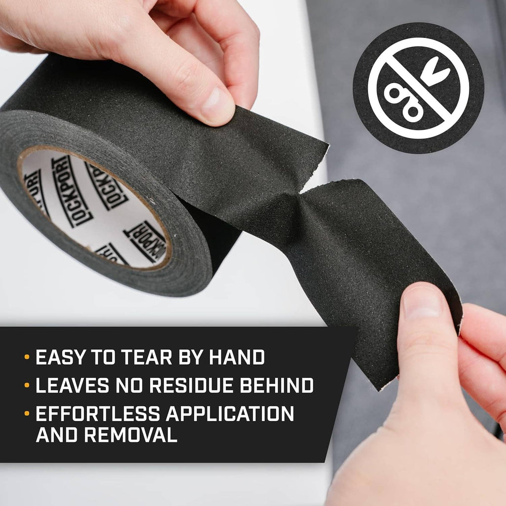 Black gaffer tape being pulled by hand from a roll, matte cloth finish