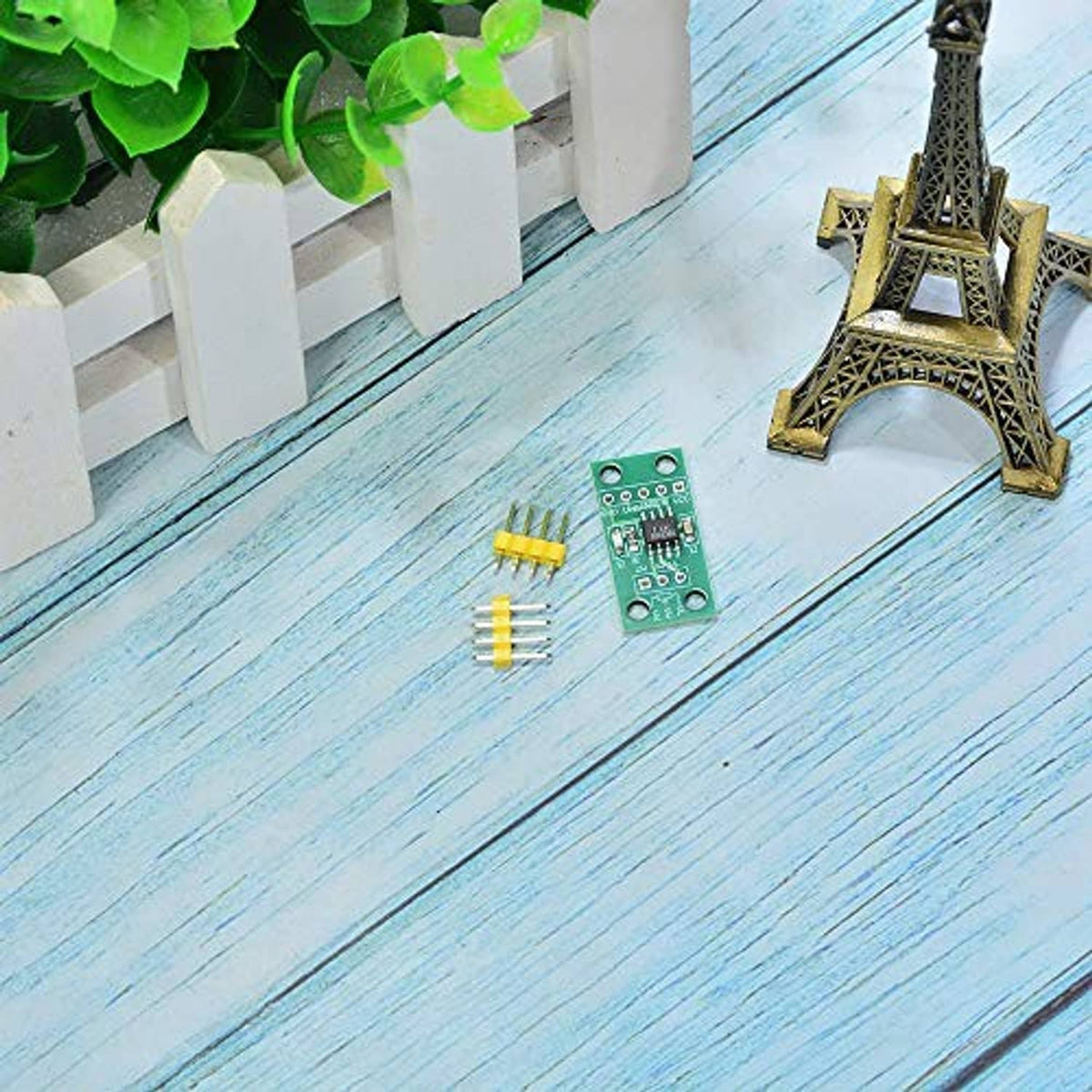 Green PCB digital potentiometer module with yellow pin header pieces