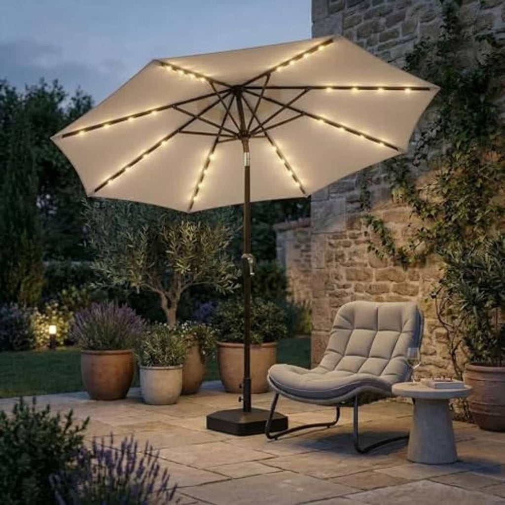 Beige outdoor patio umbrella with warm LED string lights over patio seating