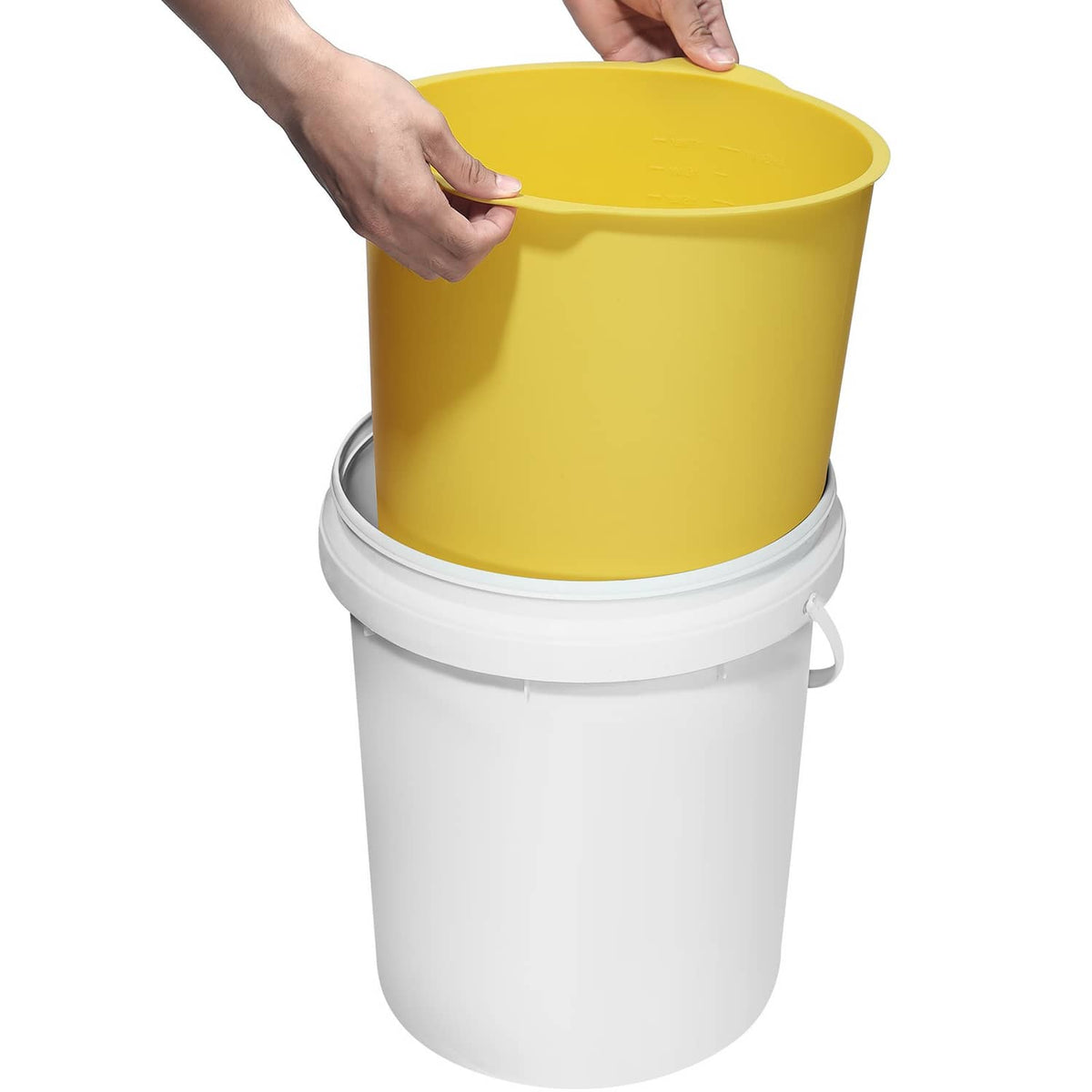 Yellow silicone bucket liner seated on a white 5-gallon bucket