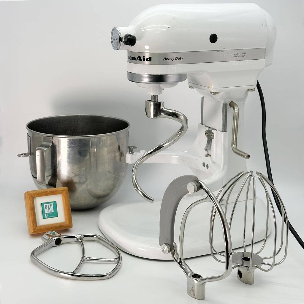 Stainless steel dough hook attachment on white bowl-lift stand mixer
