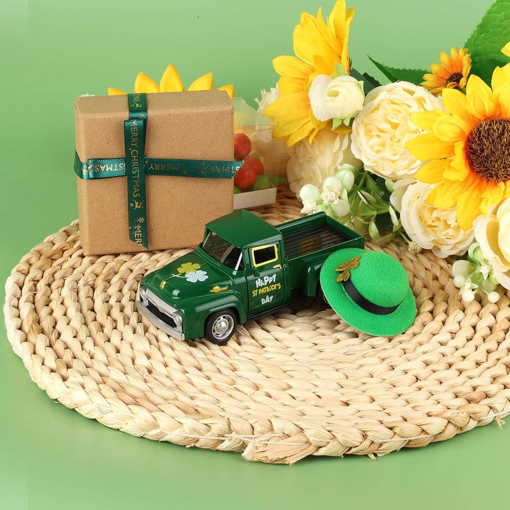 Green mini die-cast pickup with St. Patrick's Day print and green hat on woven mat